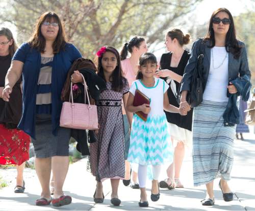 Rick Egan  |  The Salt Lake Tribune

Nelly Berdomo, and Romina Berdomo, from Urugya, and Samantha and Diana Angulo, from Mexico, walk to the LDS conference center for the first session of the 185th LDS General Conference, designated as the General Women's Meeting, attended by all LDS females 8-years-old and older, Saturday, March 28, 2015.