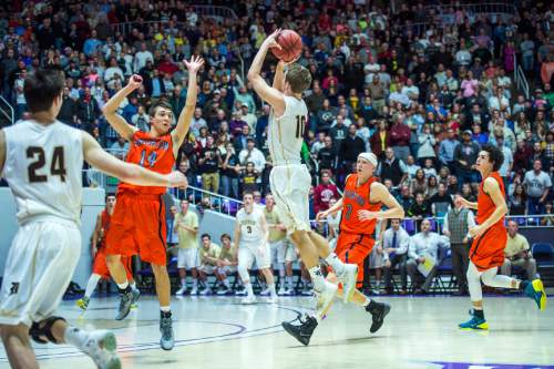 Chris Detrick  |  The Salt Lake Tribune
Guarded by Brighton's Derek Devashrayee (14), Davis' Jesse Wade (10) shoots the potential game-winning three-point shot at the buzzer during the 5A semifinal game at the Dee Events Center Friday February 27, 2015.  Brighton defeated Davis 64-62.