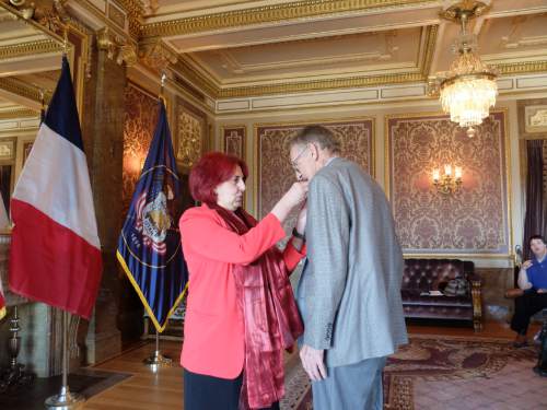 The Honorary Consul of France, Marie-Helene Glon, pins the French Legion of Honor to Sam Boyack on April 18, 2015, in a ceremony at the state Capitol. Boyack, 91, of Sandy, was in the U.S. Army Air Corps during World War II and participated in the liberation of France. Photo by Nate Carlisle/The Salt Lake Tribune