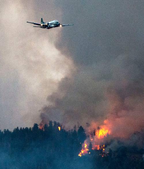 Steve Griffin  |  The Salt Lake Tribune


A plane flys along a burring ridge after dumping a load of retardant as a wildfire burns in the mountains above Levan, Utah Thursday, July 24, 2014.
