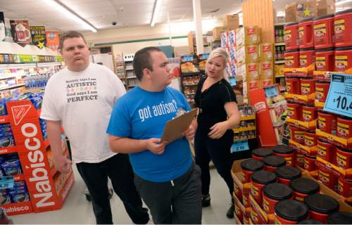 Al Hartmann  |  The Salt Lake Tribune 
Teens from the Carmen B. Pingree Autism Center of Learning accompany teacher Markell McCubbin of the adolescent program on a shopping trip to Ream's Food Store in Salt Lake City Tuesday April 14, 2015. She helps Gavynn, on left, and Carson search for merchandise on the shopping list. The students buy, sort and distribute food items with the help of teachers. It's part of a curriculum designed to prepare the students for adulthood.