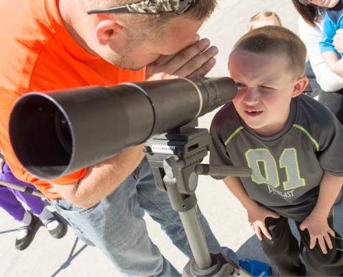 Rick Egan  |  The Salt Lake Tribune

Mason Williams, 7, Tooele, looks at a mountain goat  through a scope, with the help of his dad, Mike Williams, during the Utah Division of Wildlife Resources' annual mountain goat viewing event, at the Park-and-ride lot at the mouth of Little Cottonwood Canyon, Saturday, April 18, 2015.
