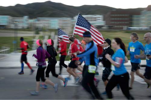 Scott Sommerdorf   |  The Salt Lake Tribune
Runners blur past as they start the Salt Lake Marathon, Saturday, April 18, 2015.