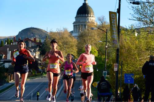 Scott Sommerdorf   |  The Salt Lake Tribune
Runners run down State Street during the Salt Lake Marathon, Saturday, April 18, 2015.