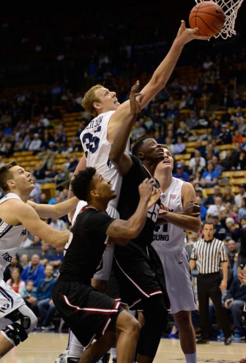 Francisco Kjolseth  |  The Salt Lake Tribune
BYU's Isaac Neilson makes a drive to the basket against UMass at the Marriott Center in Provo on Tuesday, Dec. 23, 2014.