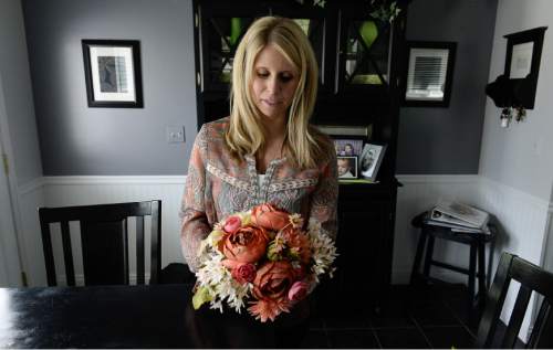 Francisco Kjolseth  |  The Salt Lake Tribune 
Heather Diston holds a bouquet of silk flowers to get a feel for the size of what to order when she gets her real flowers for her wedding in July. Her grandmother Kathy Garamendi, who has been in the business of flowers for weddings for 30 years, has seen the market in Utah become very tough with frugal clients driving the cost down.