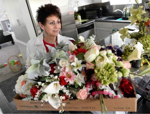 Francisco Kjolseth  |  The Salt Lake Tribune 
Kathy Garamendi, who has been in the business of selling flowers primarily for weddings for 30 years and works out of her home, uses silk flowers to illustrate size and color. The business of weddings proves to be a tough market in Utah where frugal clients drive the cost down.