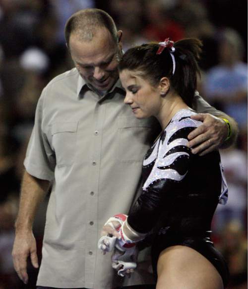 (Tribune file photo) 
Jessica Duke is consoled by Utah head coach Greg Marsden Jessica  prior to her bars routine during NCAA gymnastic championship team finals at the University of Georgia in Athens.