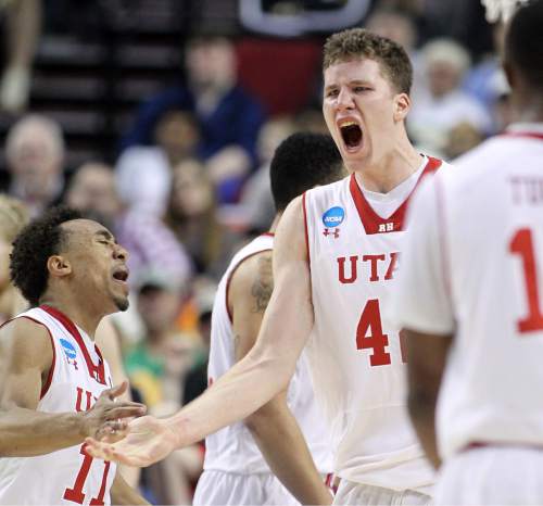 Utah guard Jakob Poeltl, right, celebrates with teammate Brandon Taylor during the second half of an NCAA college basketball second-round game against Stephen F. Austin in Portland, Ore., Thursday, March 19, 2015. (AP Photo/Craig Mitchelldyer)