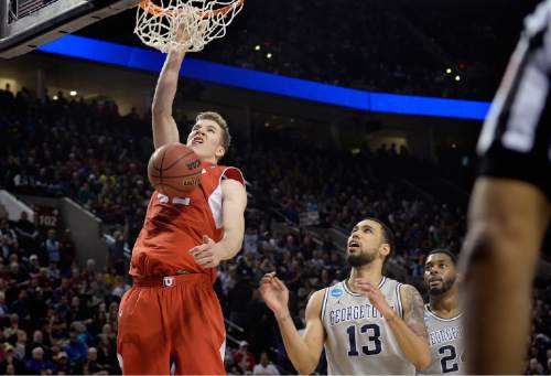 Scott Sommerdorf   |  The Salt Lake Tribune
Utah Utes forward Jakob Poeltl (42) dunks over Georgetown Hoyas forward Paul White (13) during second half play. Utah defeated Georgetown 75-64 to advance to the "Sweet Sixteen", Saturday, March 21, 2015.