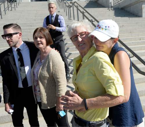 Al Hartmann  |  The Salt Lake Tribune
LGBT protestors known as the "Capitol 13" hug eachother in support in front of the Utah capitol building Thursday August 28, 2014,  They were arrested at the legislature in February for disturbing a meeting, a class B misdemeanor. They collectively announced their not guilty plea.