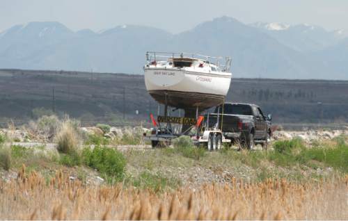 Steve Griffin  |  The Salt Lake Tribune

A sailboat leaves the Great Salt Lake State Marina on a trailer after a crane lifted it from its slip in Salt Lake City, Thursday, April 23, 2015. This time of year sailboats usually are put in, but this time 80 or so boats are scheduled to be pulled out in the face of dropping lake levels that threaten to render the marina unusable for sailing.