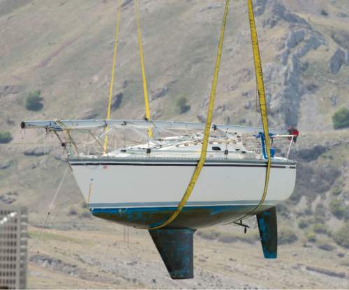 Steve Griffin  |  The Salt Lake Tribune

A crane lifts a sailboat from its slip at the Great Salt Lake State Marina in Salt Lake City, Thursday, April 23, 2015. This time of year sailboats usually are put in, but this time about 80 boats are scheduled to be pulled out in the face of dropping lake levels that threaten to render the marina unusable for sailing.
