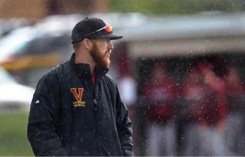 Scott Sommerdorf   |  The Salt Lake Tribune
Viewmont First base coach Lydon Toomer watches in between innings as the rain comes down. Viewmont defeated Northridge 3-1 as the rain let up and allowed a full seven innings, Friday, April 24, 2015.