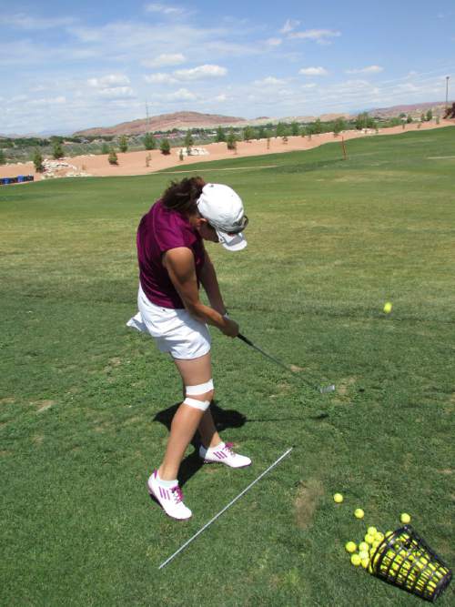 Tom Wharton  |  The Salt Lake Tribune
Desert Hills golf star Katie Perkins practices her chipping on Sun River driving range.