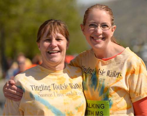Leah Hogsten  |  The Salt Lake Tribune
l-r "Tingling Tootsie Walkers" Becky Hesterman and Jana Gledhill sport fun t-shirts made by Gledhill's sister in support of Gledhill who has multiple sclerosis.   MS Walkers enter the Gateway's Olympic Legacy Plaza during the annual walk to  raise money for research on multiple sclerosis and programs and services for people with the disease.