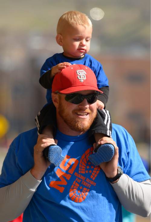 Leah Hogsten  |  The Salt Lake Tribune
Wyatt Johnson, 1, gets a ride on the shoulders of his father Trent Johnson who has multiple sclerosis. Johnson's team "Making Strides for Trent" was over a dozen people strong during their third year walking the MS event. 
 MS Walkers enter the Gateway's Olympic Legacy Plaza during the annual walk to  raise money for research on multiple sclerosis and programs and services for people with the disease.