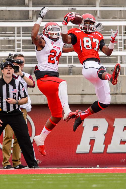 Trent Nelson  |  The Salt Lake Tribune
Jawuan Mathis pulls in an end zone interception ahead of Kenric Young at the Utah Football Red & White game in Salt Lake City, Saturday April 25, 2015.