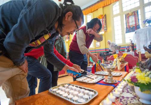 Rick Egan  |  The Salt Lake Tribune

Pasang Tsering and Taurang Dong Juns light candles before they prayed for the victims of the earthquake in Nepal with the Utah Tibet Society at the Urgyen Samten Ling Gonpa Tibetan Buddhist Temple,Sunday, April 26, 2015.