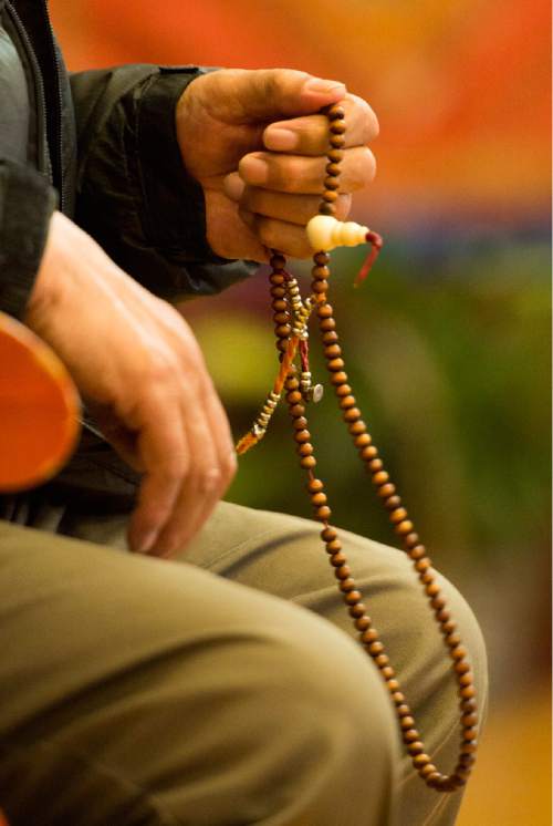 Rick Egan  |  The Salt Lake Tribune

Pema Saga holds Mani beads as he prays for the victims of the earthquake in Nepal with the Utah Tibet Society at the Urgyen Samten Ling Gonpa Tibetan Buddhist Temple,Sunday, April 26, 2015.