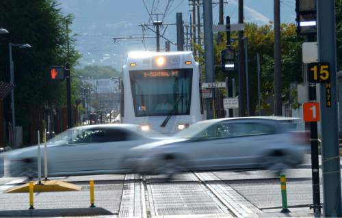 Al Hartmann  |  The Salt Lake Tribune 
Sugar House streetcar stops for car steaking by on 700 East Wednesday August 13.  It is only slightly faster than the nearby parallel bus, and pedestrians sometimes can outrace it. Far fewer people than projected are riding it. And it was expensive, $37 million. But officials still see it as a success and worth the price because of the economic development it has attracted.