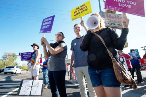 Steve Griffin  |  The Salt Lake Tribune

Same-sex marriage supporters participate in a honk and wave to support same-sex marriage arguments at the U.S. Supreme Court, outside Piper Down Pub near 1500 south and State Street in Salt Lake City, Tuesday, April 28, 2015.
