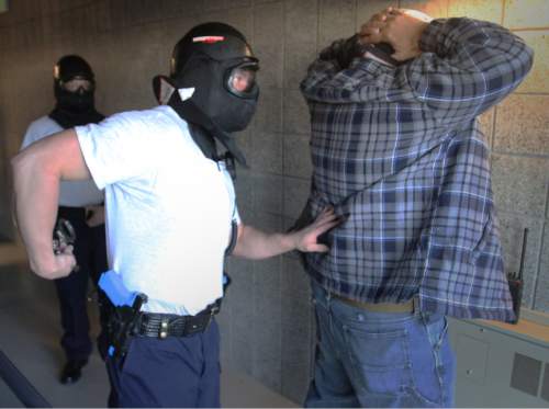 Rick Egan  | Tribune file photo

Police cadet Preston Casey (center) puts handcuffs on instructor Robert Cid (right) as Jason Goode looks on (left) at the police academy on the Miller Campus of SLCC Thursday, March 15, 2012. Utah's police council can discipline police officers.