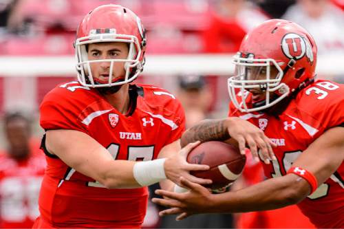 Trent Nelson  |  The Salt Lake Tribune
Quarterback Conner Manning hands off the ball to Tani Leha'uli at the Utah Football Red & White game in Salt Lake City, Saturday April 25, 2015.