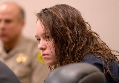 Al Hartmann  |  Tribune file photo
Meagan Grunwald, a teen charged in connection with a fatal officer shooting in Utah County, listens to testimony in her preliminary hearing in Judge Darold McDade's courtroom in Provo Wednesday April 16, 2014.