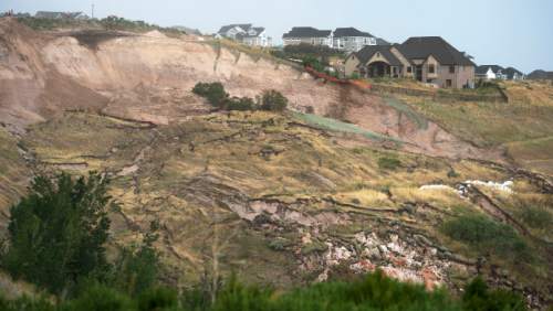 Steve Griffin  |  Tribune file photo

Steve Griffin  |  Tribune file photo
Heavy rains caused this mountain side to slide, destroying a home, bottom, Tuesday, August 5, 2014.