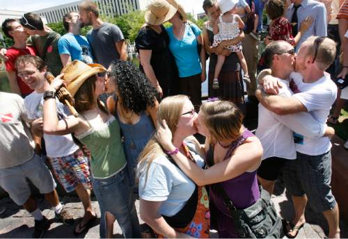 KISS-IN 2
Protesters kiss while standing in Temple Square, Sunday 7/19/09. In solidarity with Derek Jones and Matthew Aune, arrested and handcuffed July 8 for a display of public affection on Main Street Plaza, protesters have organized a second "kiss-in" follow-up to the original July 12 "kiss-in." The July 12 protest drew 100 people. This follow-up may attract more, Sunday, 7/19/09.
Scott Sommerdorf  / The Salt Lake Tribune