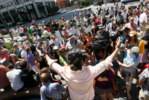 KISS-IN 2
Protestor Lee Madrid urges the crowd of protesters to walk into Temple Square and protest the Church's stance on homosexuality Sunday 7/19/09. In solidarity with Derek Jones and Matthew Aune, arrested and handcuffed July 8 for a display of public affection on Main Street Plaza, protesters have organized a second "kiss-in" follow-up to the original July 12 "kiss-in." The July 12 protest drew 100 people. This follow-up may attract more, Sunday, 7/19/09.
Scott Sommerdorf  / The Salt Lake Tribune