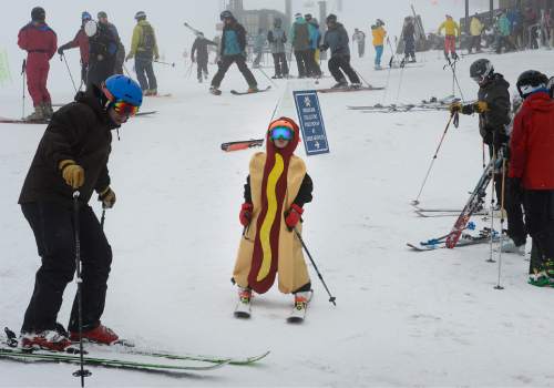 Scott Sommerdorf   |  The Salt Lake Tribune
Quinn Steffen, 8, and his Dad Jim, left, enjoy the foggy day at Alta, Sunday, April 25, 2015. For only the second time in the last 50 years, Alta Ski Area has not reached a 100-inch base.