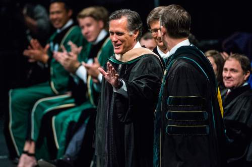 Chris Detrick  |  The Salt Lake Tribune
Mitt Romney waves after receiving an Honorary Doctorate of Business during Utah Valley University's Commencement Ceremonies at the UCCU Events Center Thursday April 30, 2015.