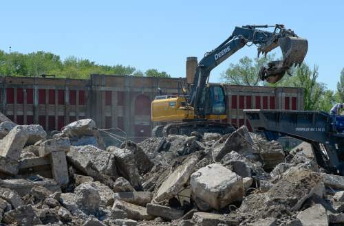Francisco Kjolseth  |  The Salt Lake Tribune 
Crews crush piles of concrete in front of the historical Exchange Building at the Ogden Stockyards as they make way for a new business park for new companies, likely outdoor industries.