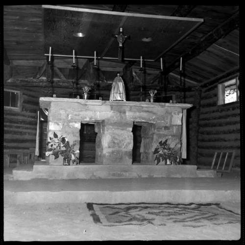 Salt Lake Tribune archive

The Common Room, also used in church services, at St. Cristopher's Mission in Bluff, Utah, 1950. St. Christopher's Episcopal Mission was established in 1943 when H. Baxter Liebler, an Episcopal priest from Old Greenwich, Connecticut came to Bluff to establish a mission among the Navajo people. St Christopher's is named after the patron saint of travelers.  When Father Liebler arrived in Bluff, there were no missions, schools, or medical/hospital facilities for the Navajo living in this remote Utah section of the reservation. Before arriving in southeast Utah, Father  Liebler studied the Navajo language to make his message comprehensible to the Dineh and compatible with their understanding of harmony.  He participated in Navajo ceremonies, wore his hair in the traditional Navajo style-long, pulled back and wrapped. A year after the mission was established, a school was started which became the only school for the 1,500 Navajo living in the central part of the Utah strip of the Navajo Reservation. A hospital/ clinic building was completed in 1956.  An estimated 500 babies were born in the clinic during the years it was in operation.