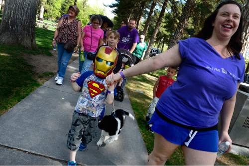 Scott Sommerdorf   |  The Salt Lake Tribune
Jonathan Mason, who has a cousin with Lupus, walks in his Iron Man mask along with his mother Christina Mason, right, in The Walk to End Lupus Now at Liberty Park in Salt Lake City, Saturday, May 2, 2015. This year marks the 30th anniversary of the Utah Lupus Chapter.