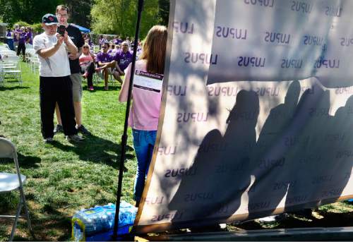 Scott Sommerdorf   |  The Salt Lake Tribune
Walk participants make photos of each other in front of the Lupus banner at The Walk to End Lupus Now at Liberty Park in Salt Lake City, Saturday, May 2, 2015.