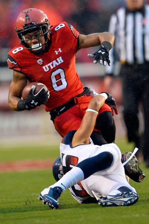 Chris Detrick  |  The Salt Lake Tribune
Utah Utes wide receiver Kaelin Clay (8) is tackled by Arizona Wildcats safety Jourdon Grandon (26) during the game at Rice-Eccles Stadium Saturday November 22, 2014.
