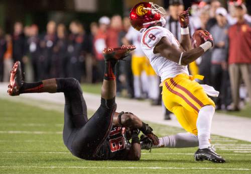 Rick Egan  |  The Salt Lake Tribune

Utah Utes defensive back Eric Rowe (18) brings down USC Trojans wide receiver JuJu Smith (9) in Pac-12 action, Utah vs. USC, at Rice-Eccles Stadium, Saturday, October 25, 2014.