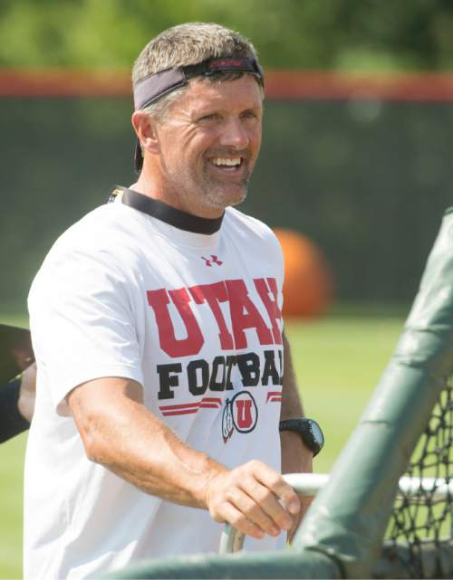 Rick Egan  |  The Salt Lake Tribune

Head coach Kyle Whittingham, watches the  home run derby contest, after the University of Utah football practice, Saturday, August 9, 2014