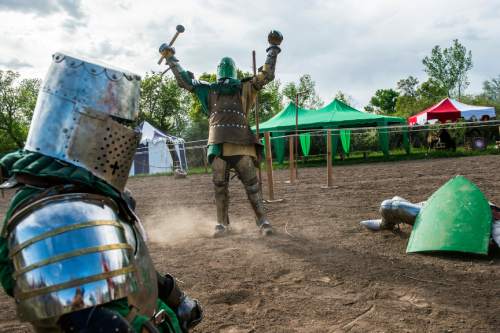 Chris Detrick  |  The Salt Lake Tribune
Armored Combat League member David C. Smith, center, celebrates his victory over Jackson Meats, right, and Ben Warth at the The Utah Renaissance Festival & Fantasy Faire in Marriott-Slaterville on Saturday. It opened Friday and continues 10 a.m.-6 p.m. on Sunday. It will be open every Friday, Saturday and Sunday through May 24.