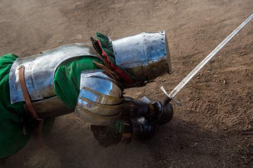 Chris Detrick  |  The Salt Lake Tribune
Armored Combat League member Ben Warth falls to the ground during a fight at the The Utah Renaissance Festival & Fantasy Faire in Marriott-Slaterville Saturday May 2, 2015.  It opened Friday and continues 10 a.m.-6 p.m. on Saturday and Sunday. It will be open every Friday, Saturday and Sunday through May 24.