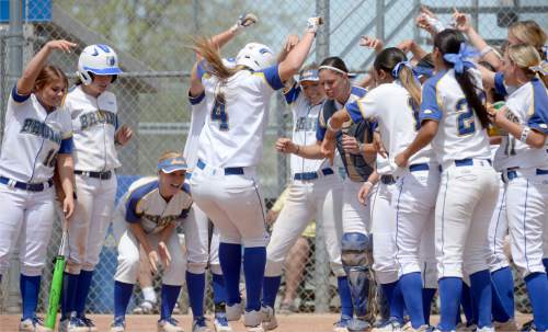Al Hartmann  |  The Salt Lake Tribune
SLCC softball player Riana Splinter hops in the air landing on home plate as her teammates cheer her on.  She just hit a home run in the second inning against the Golden Eagles of Southern Idaho Friday May 1 to score the first run of the game.