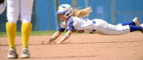 Al Hartmann  |  The Salt Lake Tribune
SLCC softball player Corrine Cleverly takes a long slide into second base against the Golden Eagles of Southern Idaho Friday May 1.  It was close but she was ruled out.