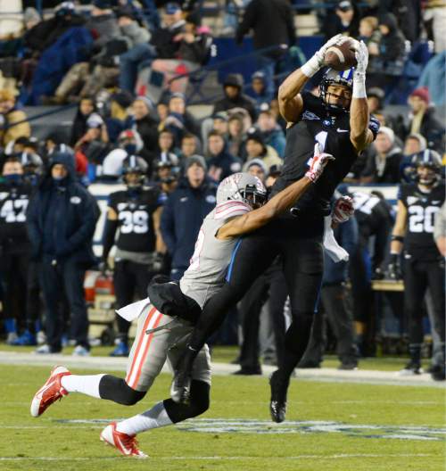 Steve Griffin  |  The Salt Lake Tribune

Brigham Young Cougars wide receiver Ross Apo (1) leaps into the air as he makes a catch over UNLV Rebels defensive back Tajh Hasson (29) during first half action in the BYU versus UNLV football game at LaVell Edwards Stadium in Provo, Saturday, November 15, 2014.