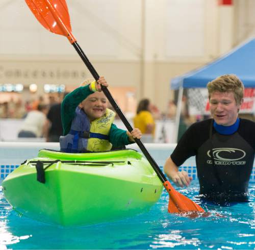 Rick Egan  |  The Salt Lake Tribune

Benjamin Coulam, 6, paddles a kayak as Emmeron Jensen, 17, assists, at the Utah Scouting Expo at the South Towne Expo Center, Saturday, May 2, 2015.