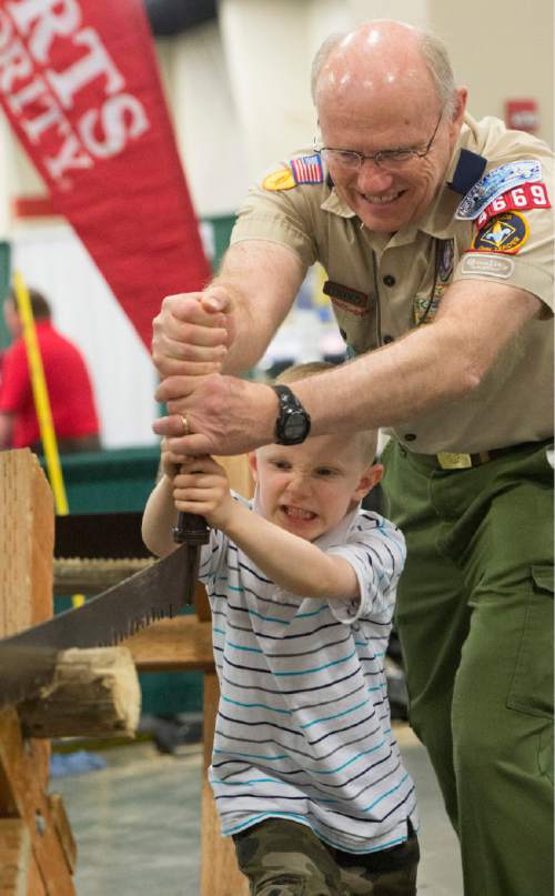 Rick Egan  |  The Salt Lake Tribune
Eric Lindgren, 6, helps his grandpa, Ron Holt, saw a log with a two-man saw, at the Utah Scouting Expo at the South Towne Expo Center, Saturday, May 2, 2015.