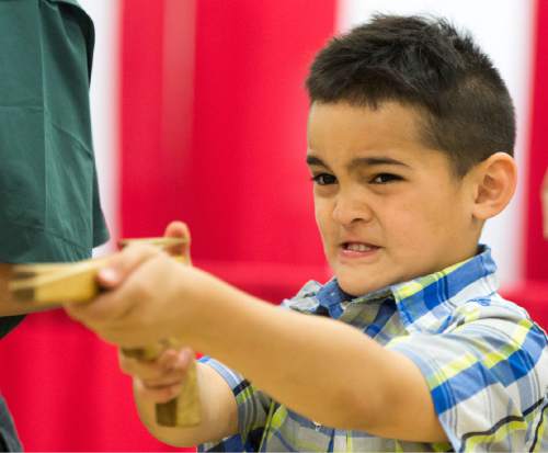 Rick Egan  |  The Salt Lake Tribune

Kiliati Fuahala, 6, takes aim as he shoots a rubber band gun, at the Utah Scouting Expo at the South Towne Expo Center, Saturday, May 2, 2015.