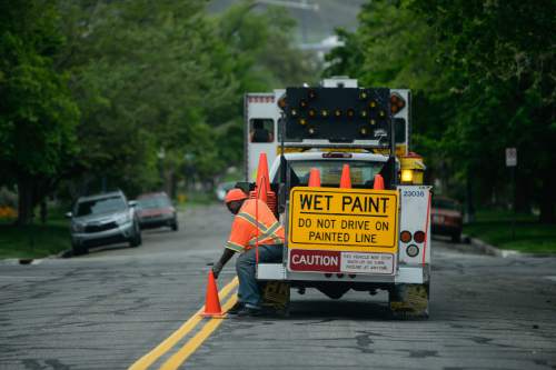 Francisco Kjolseth  |  The Salt Lake Tribune 
Salt Lake City crews paint new road stripes in the Avenues neighborhood on Tuesday, May 5, 2015, as part of the spring neighborhood cleanup.